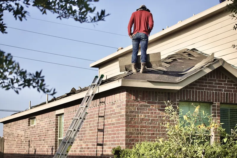 Professional roofer working on a residential roof in Todds Tavern